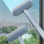 Window cleaning tool with a long handle cleaning a window.
