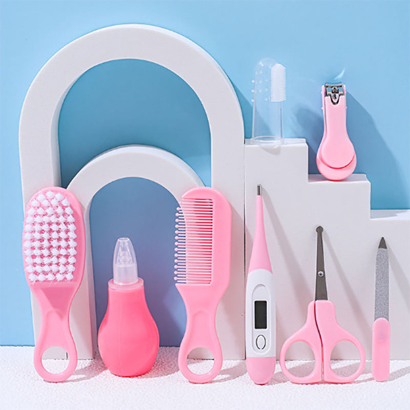 Collection of baby care products including a brush, bottle, comb, and scissors on a blue background.